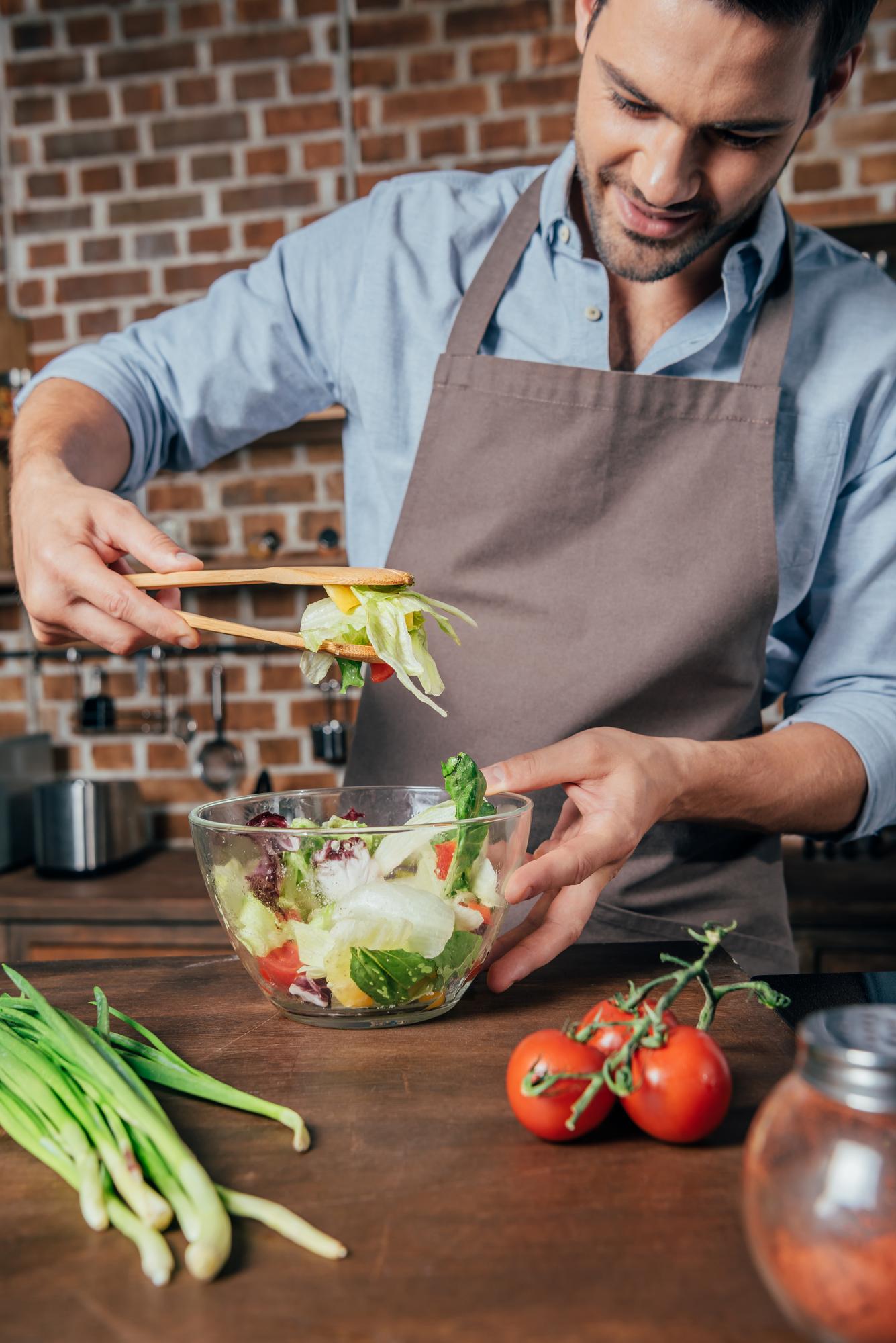 Local chef preparing a seasonal salad in a small kitchen
